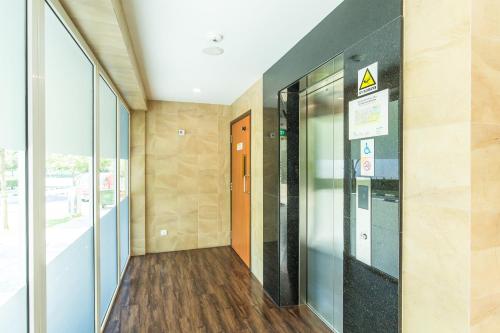 an empty hallway of an office building with an elevator at Fragrance Hotel - Viva in Singapore