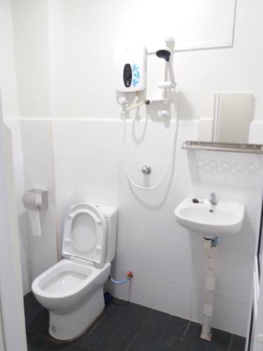a bathroom with a toilet and a sink at JS Guest House Air Putih - Roomstay in Kuantan