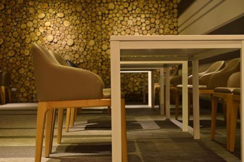a row of chairs and tables in a room at Airline Inn Green Park Way in Taichung