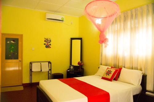 a bedroom with a bed with a pink balloon above it at Sigiri Sithru Home Stay in Sigiriya