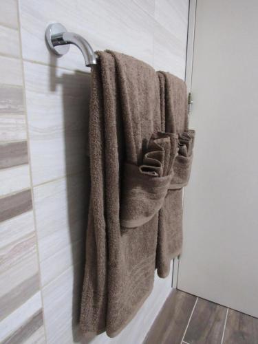 a bathroom with towels hanging on a door at Central Studio Apartment in Santa Venera