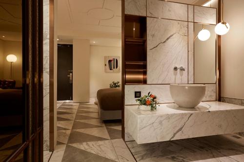a bathroom with a large bowl on a counter at 9 Brick Hotel in Seoul