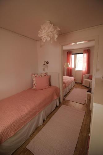 a bedroom with two beds and a window at Lövås Gård Koppera in Charlottenberg