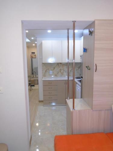 a kitchen with white cabinets and a counter top at Apartment ANI in Vagharshapat