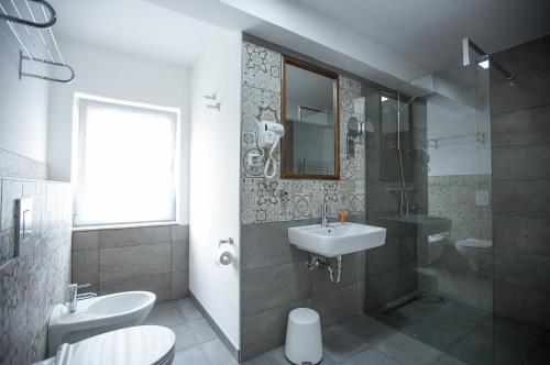 a bathroom with a sink and a shower at Heartland City B&B in Tuzla