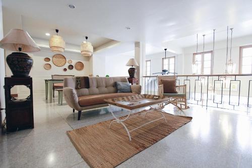 a living room with a couch and a table at Vera Nidhra - Self check-in after 6pm in Bangkok