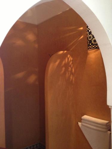 a bathroom with a toilet and a wall at Riad Mehdia in Marrakech