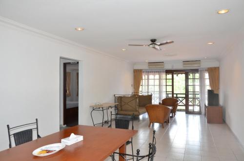 a living room with a table and chairs at Nongsa Point Marina in Nongsa