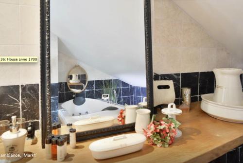 a bathroom with a sink and a mirror on a counter at Artagnan in Maastricht