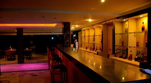 a bar in a restaurant with a person standing behind it at Nayagara Hotel in Chennai