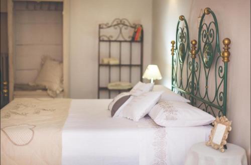 a bedroom with a large bed with white pillows at Cantina del Convento Maison in Chieri