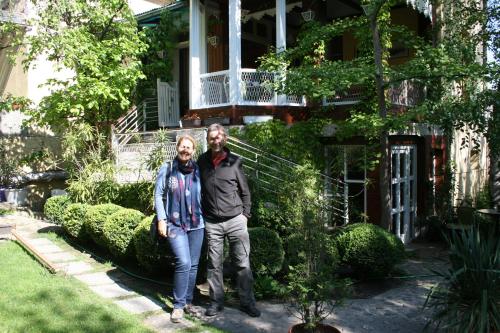 a man and a woman standing in front of a house at Base for Adventurers - Urban Guerrilla in Negotin