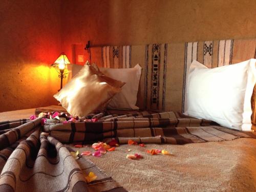 a bedroom with a bed with flowers on it at Riad Mehdia in Marrakech