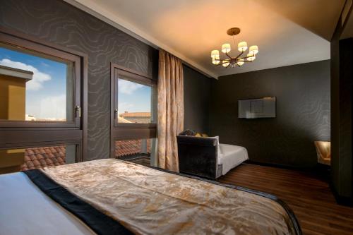 a bedroom with a large bed and a window at Palazzo Veneziano - Venice Collection in Venice