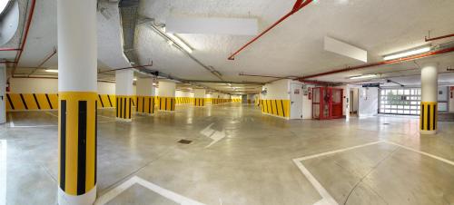 an empty parking garage with yellow and white columns at Hotel Ariston in Campodarsego