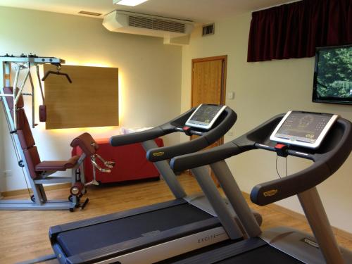 a gym with two tread machines and a treadmill at Villa Fiorita in Monastier di Treviso