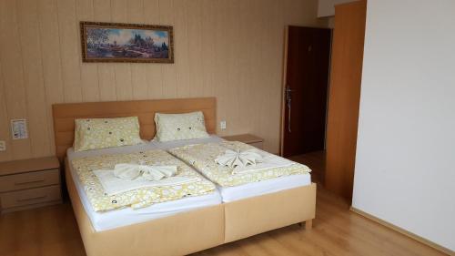a bedroom with a bed with two towels on it at Pension U Dubu in Františkovy Lázně