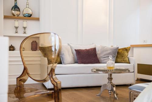 a living room with a white couch and a mirror at Casa Kallergi in Chania Town