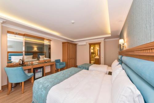 a hotel room with a bed and a desk at Magnaura House Hotel in Istanbul