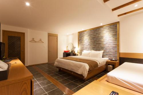 a hotel room with two beds and a television at Hotel Leaders in Seoul