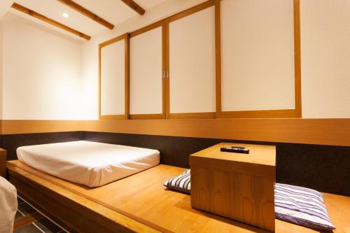 a room with a bed and a table in it at Hotel Leaders in Seoul