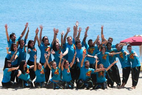 a group of people in blue shirts on the beach at Club Esse Sunbeach in Squillace