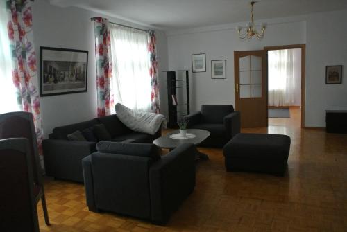 a living room with a couch and chairs and a table at Zajazd pod Zamkiem in Kętrzyn