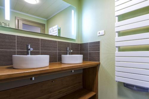 a bathroom with two sinks and a mirror at Gite Spa les Estinnes in Estinnes-au-Mont
