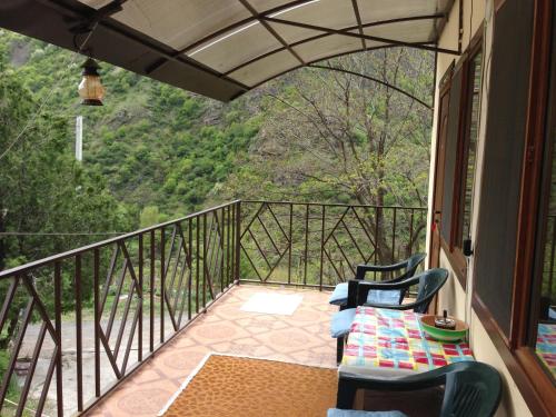 a balcony with chairs and a table with a view at IRIS B&B in DEBED CANYON in Alaverdi