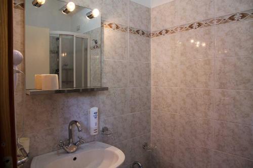 a bathroom with a sink and a mirror at Hotel Silvia Framura - Cinque Terre in Framura