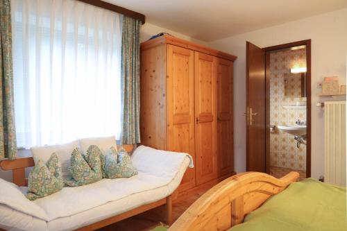 a living room with a couch and a window at Bio & Vegi Pension Krennleiten in Schönau am Königssee