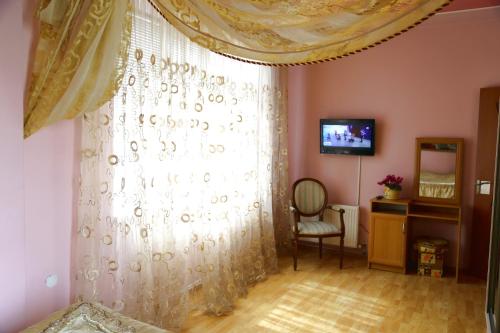 a bedroom with a bed and a window and a television at Apartment.md in Chişinău
