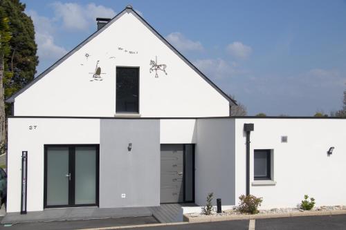 a white house with black doors and windows at MOR-HA-MARCH Chambres d'Hôtes in Sarzeau