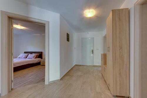 an empty room with a bed and a closet at Yokana Villa & Pool in Virpazar