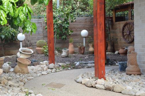 a garden with a bunch of vases and other plants at Czarina Cabin הבקתה הקיסרית והדירה הקיסרית czarina apartment in Caesarea
