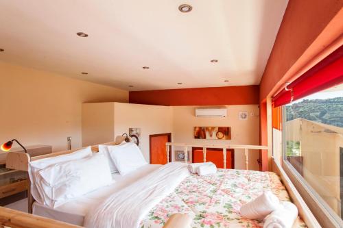 a bedroom with a large bed and a window at Estate Kares in Tílisos