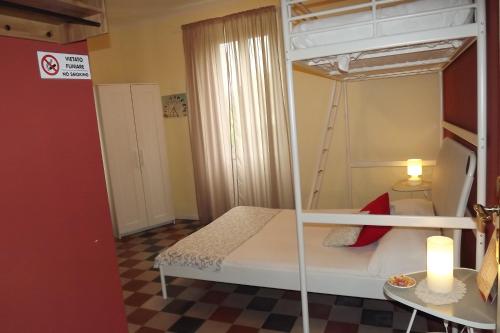 a small room with a bunk bed and a table at B&B Il Tempo Del Vento in front of the Castle in Tresana