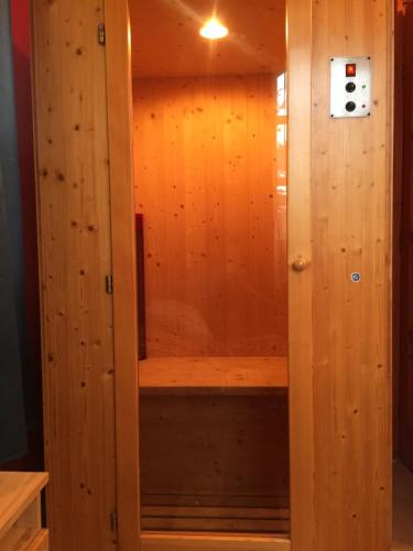 a wooden sauna in a room with wood paneling at Aranypatkó Vendégház Lovasudvar in Berzence