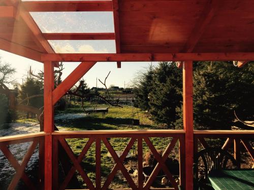 a view from the porch of a wooden structure at Aranypatkó Vendégház Lovasudvar in Berzence