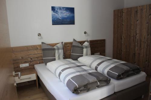 a bed with two pillows on top of it at Haus Bichali in Sankt Anton am Arlberg