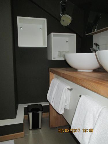 a bathroom with a sink and towels on a counter at B&B Roseland in Bruges