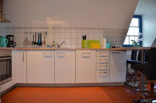 a kitchen with white cabinets and a counter top at Hofgut Wollin GmbH in Putgarten