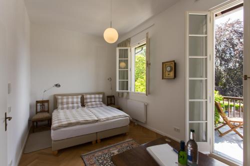 a bedroom with a bed and a window at Landhaus Reverchon in Filzen