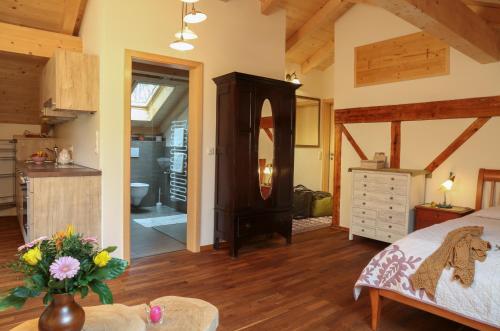 a large bedroom with a bed and a kitchen at Bio & Vegi Pension Krennleiten in Schönau am Königssee