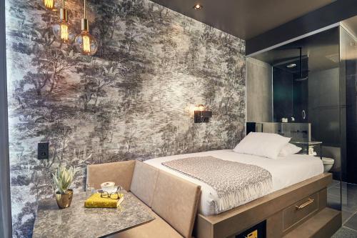 a bedroom with a bed and a wall mural at Van der Valk Hotel Brussels Airport in Diegem