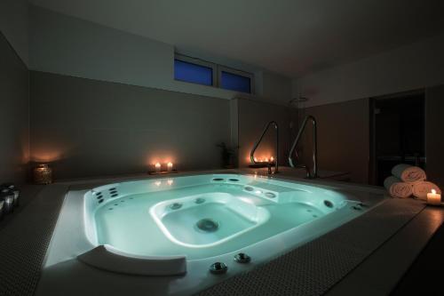 a jacuzzi tub in a room with two candles at Axel TWO Berlin - Adults Only in Berlin