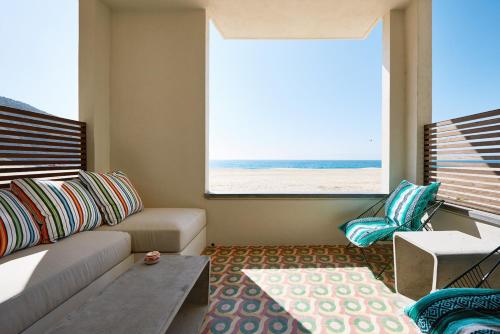 a living room with a couch and a view of the beach at Hotel San Cristobal Adults 15+ in Todos Santos