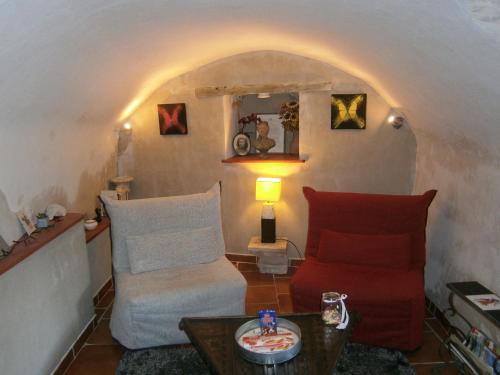 a living room with a couch and a table at Gite l'Etape in Vallon-Pont-dʼArc