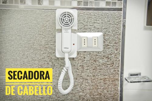 a corded phone is attached to a wall at Le Prince Arica in Arica