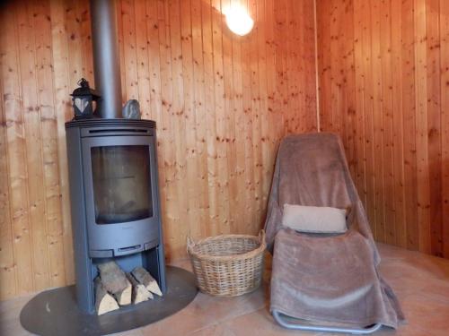 a living room with a tv and a chair at Ferienhaus Bella Vista in Presseggersee